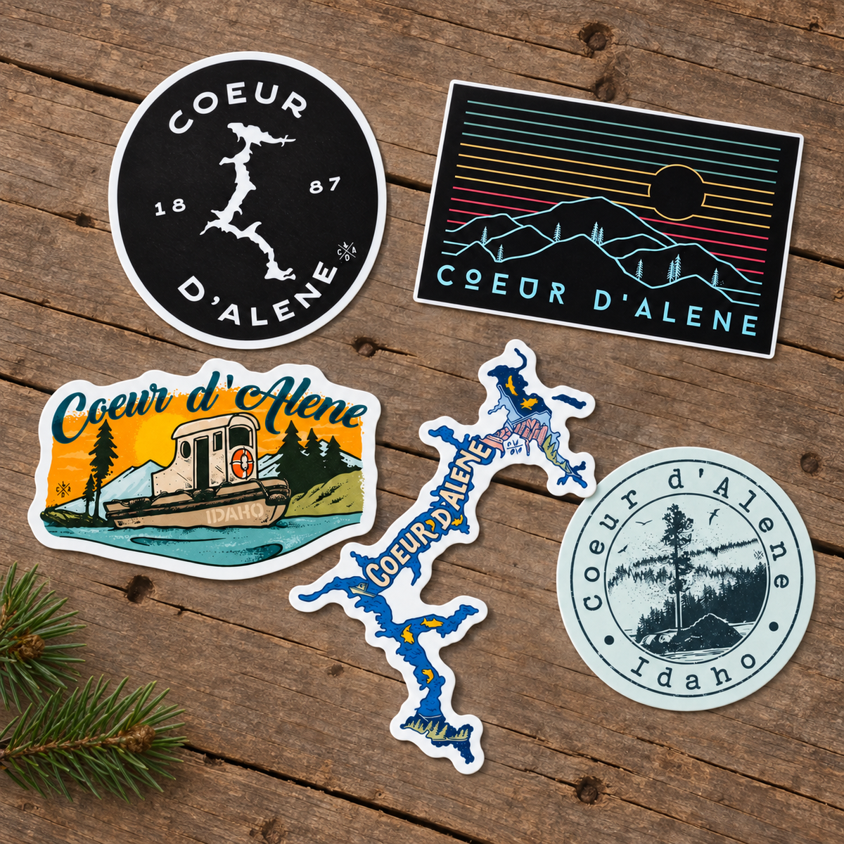 Coeur d'Alene Idaho stickers arranged on rustic wood