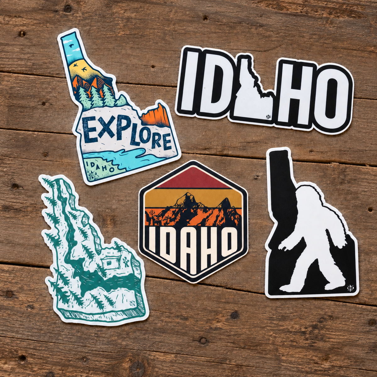 Idaho stickers arranged on rustic wood