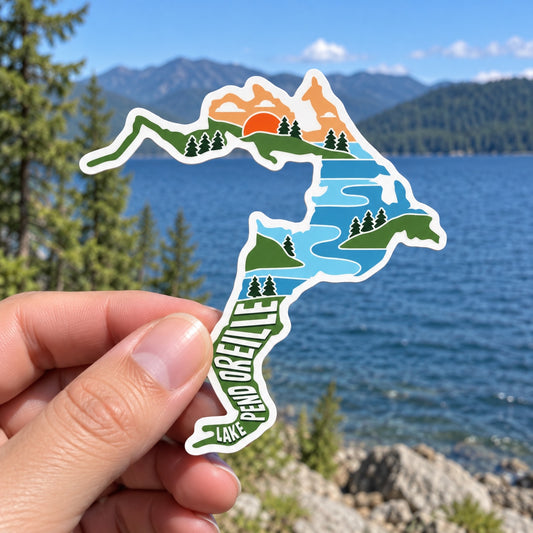 Lake Pend Oreille Scene sticker held outdoors by the lake