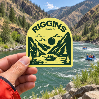 Raft Riggins Idaho sticker held outdoors above the Salmon River