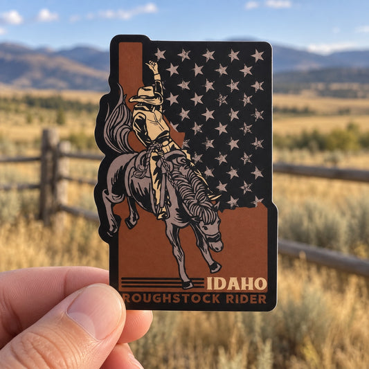Idaho Roughstock Rider sticker held outdoors in Idaho ranch country