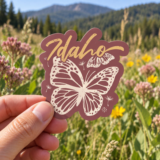 Idaho Monarch Butterfly sticker held outdoors
