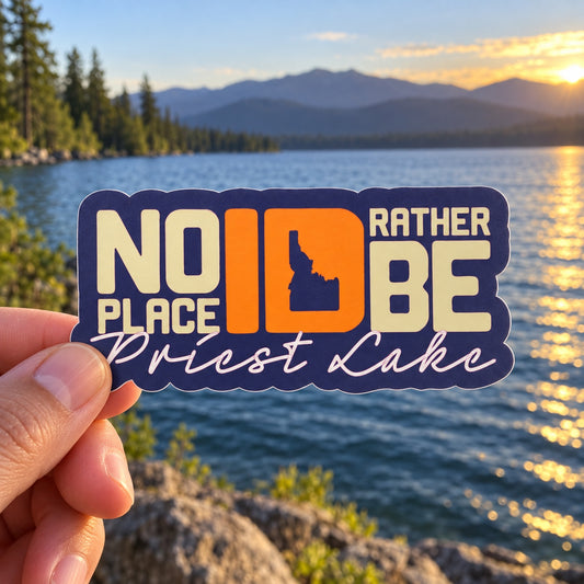 No Place ID Rather Be Priest Lake sticker held outdoors by Priest Lake