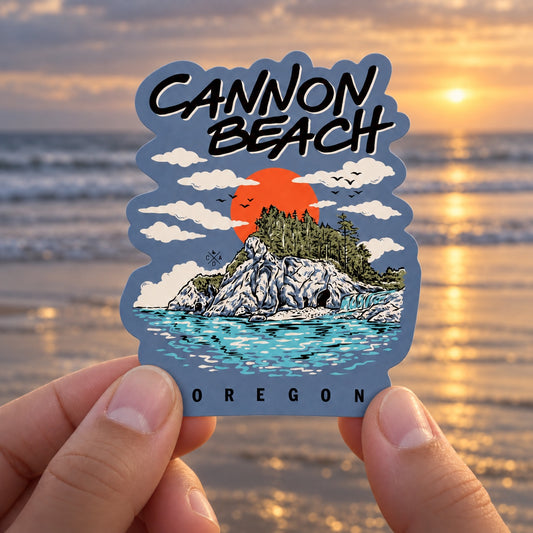 Cannon Beach Oregon sticker held outdoors by the Oregon coast at sunset