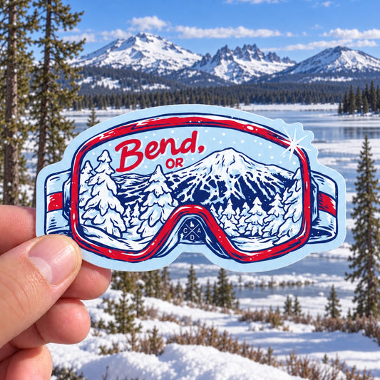 Bend Oregon ski goggle sticker held outdoors at snowy Sparks Lake