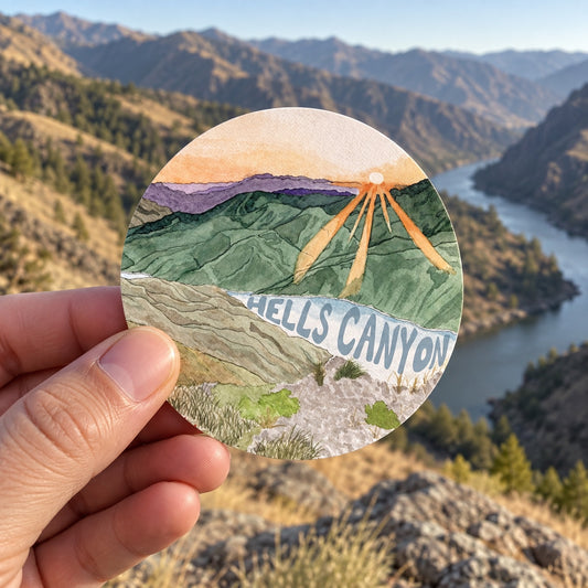 Hells Canyon Idaho Watercolor sticker held outdoors